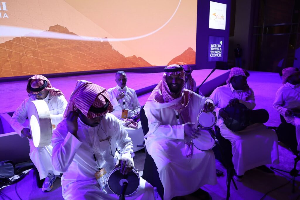 Traditional Saudi percussion musicians performing live on stage during a large-scale cultural event